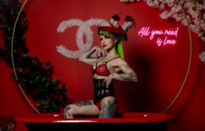 Honey sits in red tub